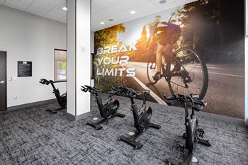 A wall mural in an office gym with a cyclist on a bike